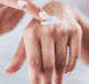 Person applying hand balm to hands
