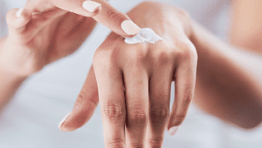 Person applying hand balm to hands