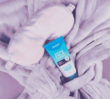 Overnight Face Repair tube on a robe with a sleep mask