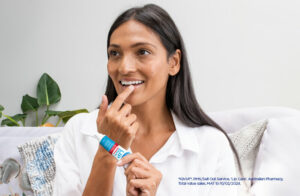 A woman applying Dermal Therapy’s Urea Lip balm on her lips and includes the words ‘Australia’s No.1 Lip Care Brand in Pharmacy