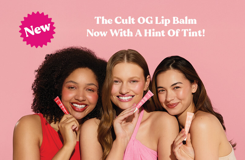 Promotional graphics with white text "The Cult OG Lip Balm now with a hint of tint!" on a light pink background including three female models, each holding a variant of the Dermal Therapy Tinted Lip Balm.