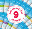 Pattern of Dermal Therapy lip balm tubes with a red circular graphic reading “One sold every 9 seconds”