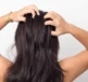 Woman feeling itchy scalp