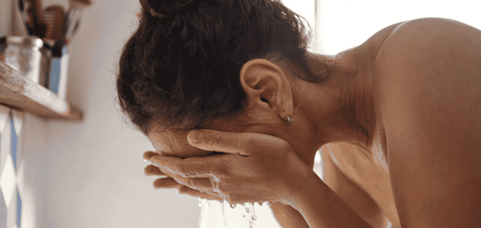A woman splashing water on her face and wondering - what are the Best Skincare Ingredients for Menopausal Skin (And What to Avoid)