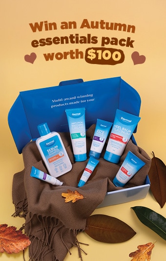 Open blue gift box containing Dermal therapy skincare products arranged on a brown cloth, surrounded by autumn leaves, with promotional text that reads ‘Win an Autumn essentials pack worth $100.