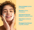 Person applying face cleanser with ingredient highlight text shown alongside.