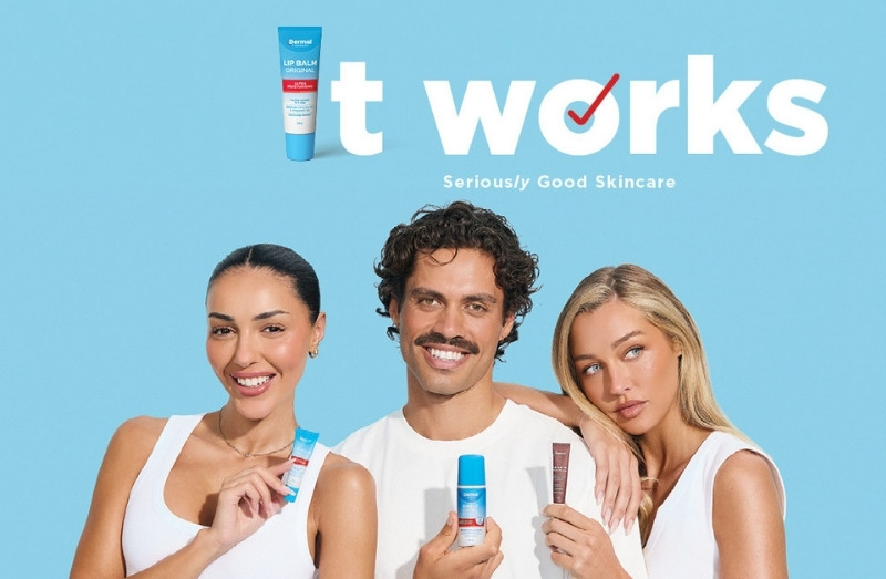 Three people holding Dermal Therapy products beneath the It Works campaign graphic featuring a Lip Balm Original pack as the letter I on a blue background