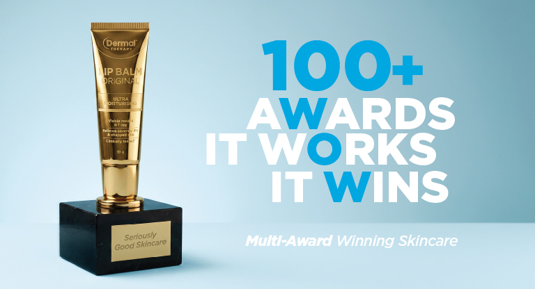 Dermal Therapy Lip Balm Original displayed on an award trophy base against a light blue background with the text “100+ Awards It Works It Wins” and “Multi-Award Winning Skincare”.